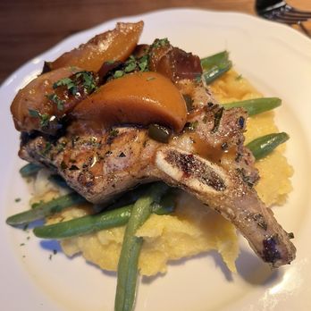 Aubrey - Pork Chop: 12 oz. Bone-in chop, peach chutney, polenta, season veggie - American Near Me - St. Louis, Missouri Aubrey - Pork Chop: 12 oz. Bone-in chop, peach chutney, polenta, season veggie - American Near Me - St. Louis, Missouri