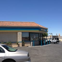a silver car parked in front of a restaurant