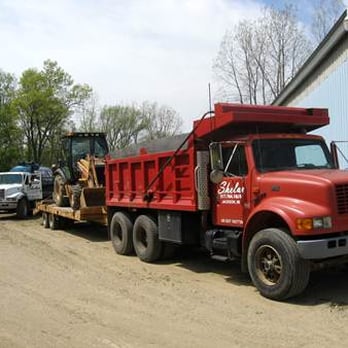Shelar Sanitation - a red dump truck and a white truck - General Contractors Near Me - Jackson, Michigan Shelar Sanitation - a red dump truck and a white truck - General Contractors Near Me - Jackson, Michigan