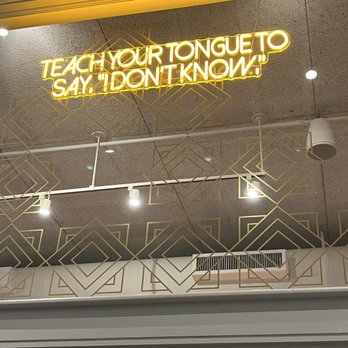Lehrhaus - Sign in the restaurant says, "Teach your tongue to say, 'I don't know'". Conveys the atmosphere of the restaurant. - Cocktail Bars Near Me - Somerville, Massachusetts