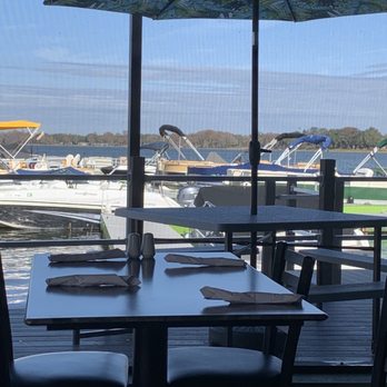 Lake Eustis Waterfront Grille - From the screened dining area, to the outside dining, to the docked boat area. - Seafood Near Me - Eustis, Florida