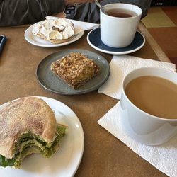 Steve O Reno's Cappuccino - Bagel with cream cheese, green egg-o-reno breakfast sandwich, yummy oatmeal/peach bar, brewed coffee and tea.