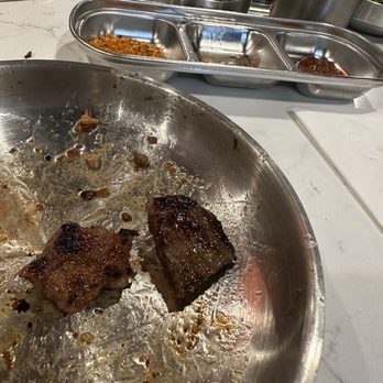 Bawi Korean BBQ - half eaten steak in a pan - Barbeque Near Me - Mequon, Wisconsin Bawi Korean BBQ - half eaten steak in a pan - Barbeque Near Me - Mequon, Wisconsin