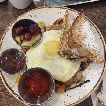 First Watch - Farmhouse hash it has bacon, tomato, potatoes, eggs, cheese, and avocado. The toast with strawberry jam and fresh fruit. - Breakfast & Brunch Near Me - Springfield, Missouri