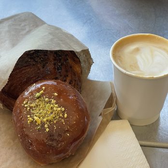 Little Flower - Firni donut, cardamom bun (in bag), cappuccino - Coffee & Tea Near Me - Astoria, New York Little Flower - Firni donut, cardamom bun (in bag), cappuccino - Coffee & Tea Near Me - Astoria, New York