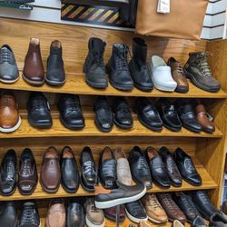 Erics Comfort Shoes - Wall display of various style boots and shoes.
