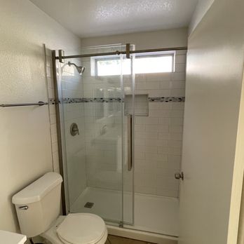 ND Construction - a bathroom with a toilet and shower - Handyman Near Me