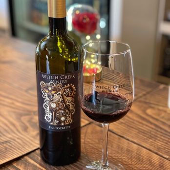 Witch Creek Winery - a glass of wine and a bottle of wine - Wine Bars Near Me - Carlsbad, California