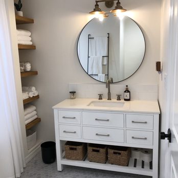 Popescu Construction - a bathroom with a sink and a mirror - General Contractors Near Me