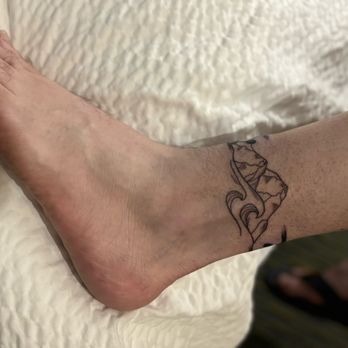 Electra Art Tattoo Studio - With mountains and waves completing the band - Tattoo Near Me - Corpus Christi, Texas Electra Art Tattoo Studio - With mountains and waves completing the band - Tattoo Near Me - Corpus Christi, Texas