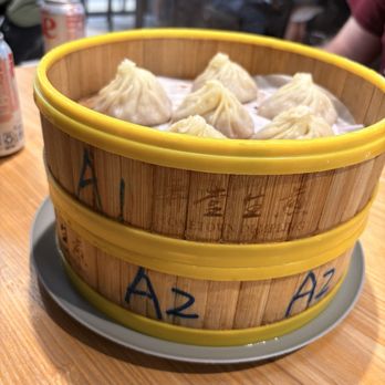 Hometown Dumpling - Dumpling served in a steamer basket, labeled with the number of your order. - Chinese Near Me - South Salt Lake, Utah