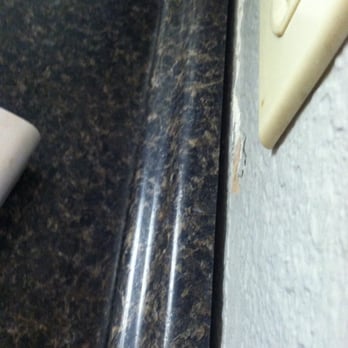 Classic Construction & Maintenance Services - Gap between backsplash and wall.  BTW, he was DONE with the job when these photos were taken. - General Contractors Near Me