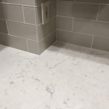 Capital Granite and Marble - The ivory glass backsplash picks up the grey from the quartz under the light - Countertop Installation Near Me - Acton, Massachusetts Capital Granite and Marble - The ivory glass backsplash picks up the grey from the quartz under the light - Countertop Installation Near Me - Acton, Massachusetts