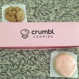 Pretty pink box with a chocolate chip and sugar cookie beside it. Pretty pink box with a chocolate chip and sugar cookie beside it.