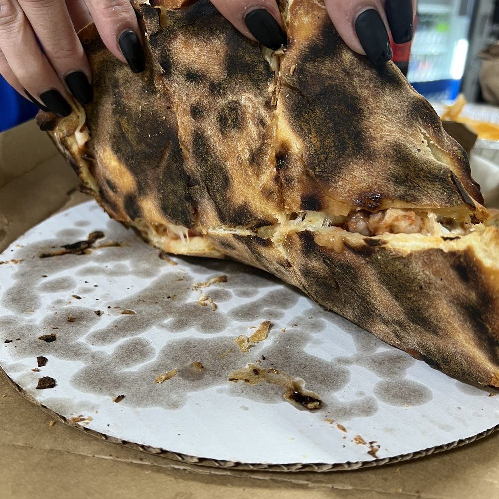 a person holding a piece of pizza a person holding a piece of pizza