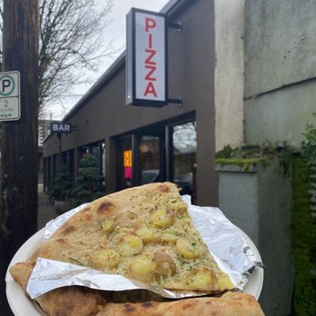Pizza Thief - Pizza! In front of their sign - Pizza Near Me - Portland, Oregon