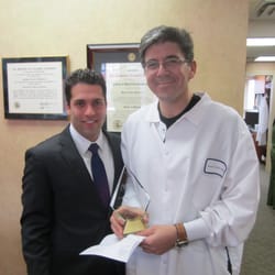 Queensboro Oral Surgery & Associates - Dr. Ochs being presented an award by Yossi of MIS Implants