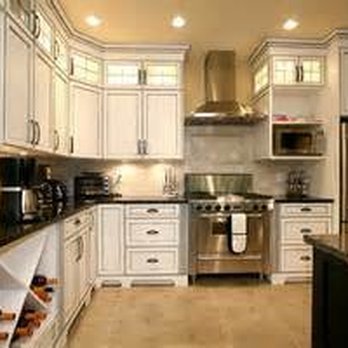Hersum Construction - a kitchen with white cabinets and black countertops - General Contractors Near Me - San Diego, California Hersum Construction - a kitchen with white cabinets and black countertops - General Contractors Near Me - San Diego, California