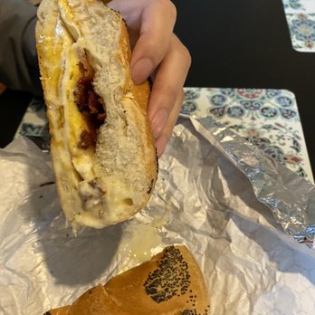 Lordship Corner Market - a hand holding a half eaten sandwich - Grocery Near Me - Stratford, Connecticut
