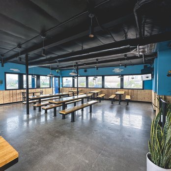 Green Cheek Beer Co. - Downstairs dining area looking towards the stairs and window - Breweries Near Me - Sunset Beach, California Green Cheek Beer Co. - Downstairs dining area looking towards the stairs and window - Breweries Near Me - Sunset Beach, California