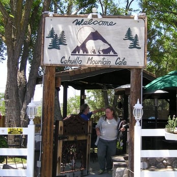 Cahuilla Mountain Market & Cafe - a woman standing in front of a sign - Barbeque Near Me - Anza, California