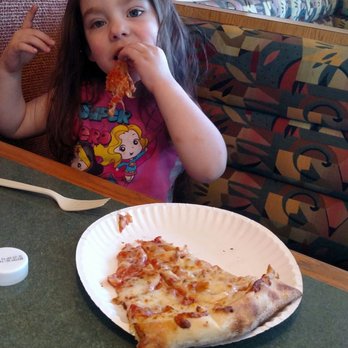 Dion's Pizza - Miss Zia digging in on a slice of cheese pizza. - Pizza Near Me - Santa Fe, New Mexico