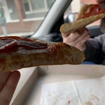 Montebello's Pizzeria & Pasta - a man eating a slice of pizza - Italian Near Me - Yonkers, New York Montebello's Pizzeria & Pasta - a man eating a slice of pizza - Italian Near Me - Yonkers, New York