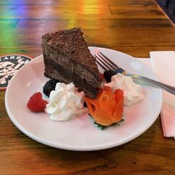 South Bay Pub & Eatery - Triple Chocolate Cake garnished with fruit and whipped cream!