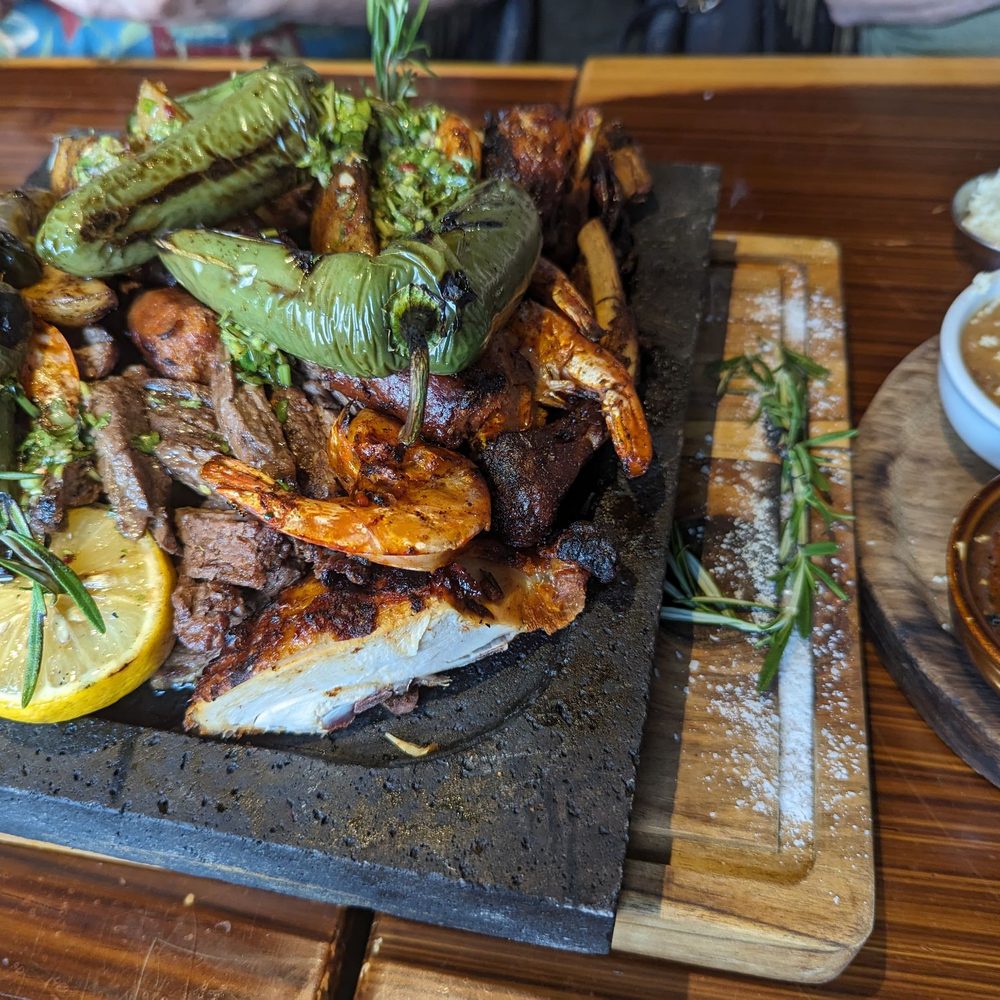 El Jefe Lena Y Mar - A tower of grilled meats and veggies flamed tableside accompanied by rice, beans, corn and tortillas to share - Seafood Near Me - Aurora, Illinois