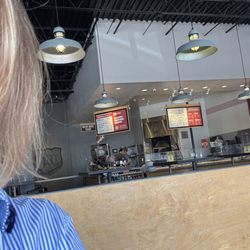MOD Pizza - The 3 employees standing and sitting looking at phone instead of cleaning up the place