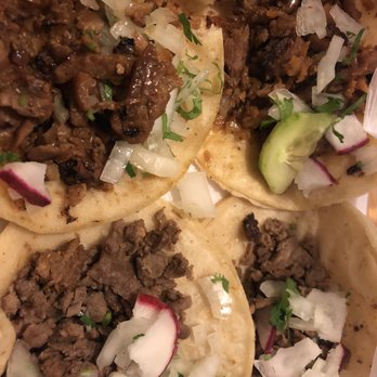 Tacos El Charly - Pastor Tacos up top (moist meat) and the Bistec Tacos on bottom - Food Trucks Near Me - Austin, Texas Tacos El Charly - Pastor Tacos up top (moist meat) and the Bistec Tacos on bottom - Food Trucks Near Me - Austin, Texas
