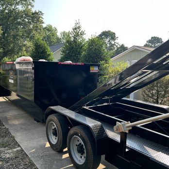 R&J Dump And Hauling Solution - Our roll off dumpster being picked up from a customers house - Trailer Rental Near Me