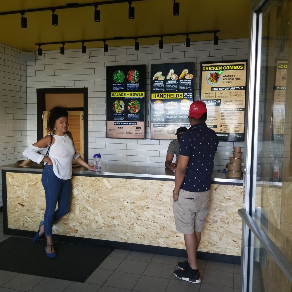 The Feed - a man and a woman standing at a counter - Sandwiches Near Me - Mississauga, Ontario The Feed - a man and a woman standing at a counter - Sandwiches Near Me - Mississauga, Ontario