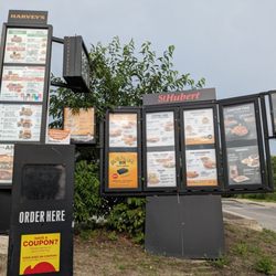 Menu at the drive-thru. It's St. Hubert and Harvey's.