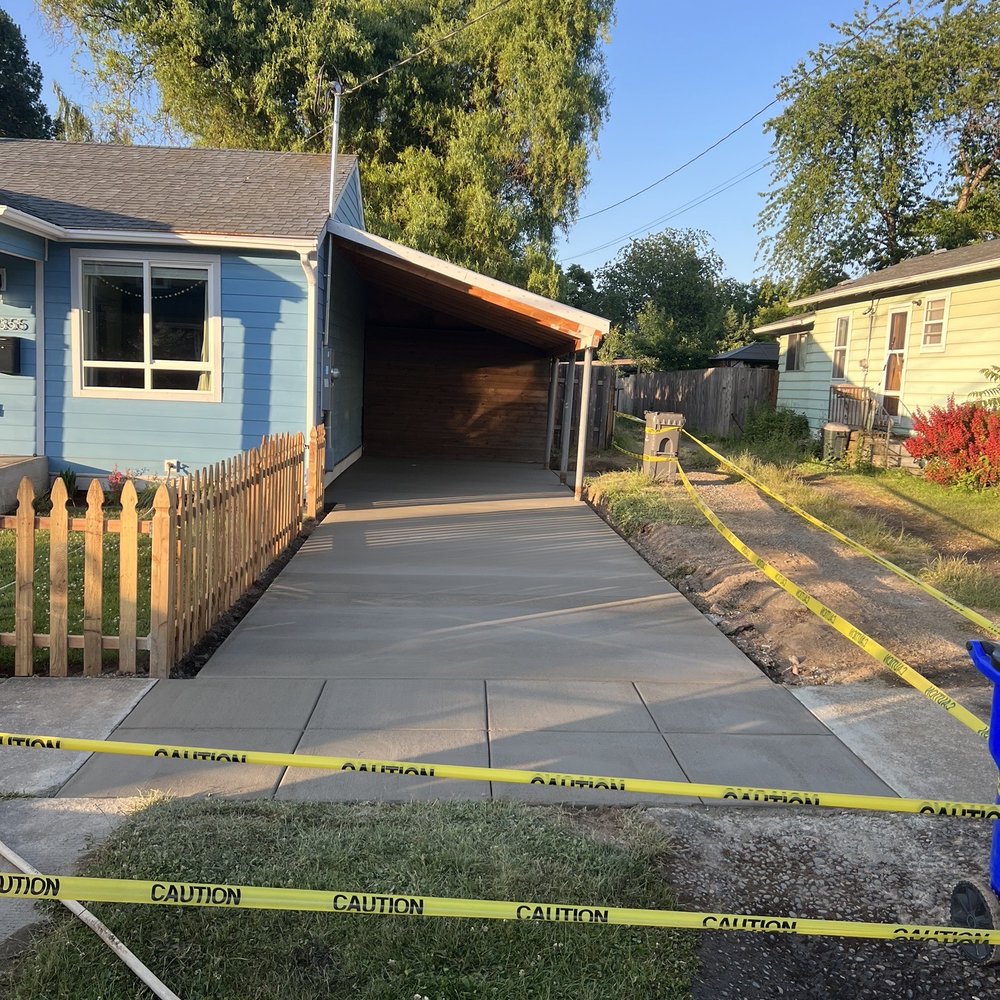 a driveway with yellow tape and a blue fire hydrant