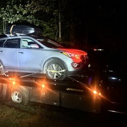 Jay expertly towed my car down a long gravel driveway, carefully avoiding branches to prevent scratches.