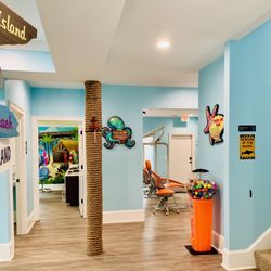Surfside Kids Pediatric Dentistry - Hallway leading to cleaning area (open concept) and private room.