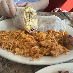 Meat lovers omelette in a roll-up ( cut in half-second half in wax paper to bring home) with hash browns .