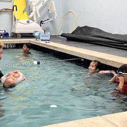 Ocaquatics Swim School Kendall - Coach Nico with our little one and other classmates