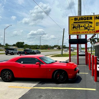 The Burger Inn - a red car parked in a parking lot - Burgers Near Me - Melbourne, Florida The Burger Inn - a red car parked in a parking lot - Burgers Near Me - Melbourne, Florida