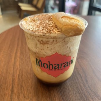 Moharani Coffee House - The Dhakamisu (tiramisu latte) complete with a ladyfinger - Coffee & Tea Near Me - Houston, Texas Moharani Coffee House - The Dhakamisu (tiramisu latte) complete with a ladyfinger - Coffee & Tea Near Me - Houston, Texas