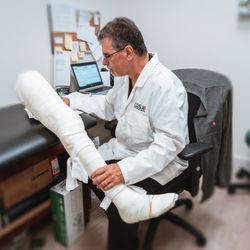 Complete Orthopedic Services - One of our practitioners looking over the cast before we make it into a custom brace
