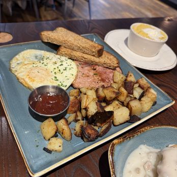 First Watch - Traditional breakfast - supposed to be 2 eggs but who's counting? Ham, seasoned potatoes, multigrain toast and a side of grits and butter - Breakfast & Brunch Near Me - Reston, Virginia