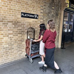 The Harry Potter Shop at Platform 9 3/4 - Helping my daughter get her pose right.