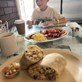 Mangy Moose Cafe - Breakfast burritos, pancake with strawberries, bacon and sausage. - American Near Me - Manteca, California Mangy Moose Cafe - Breakfast burritos, pancake with strawberries, bacon and sausage. - American Near Me - Manteca, California