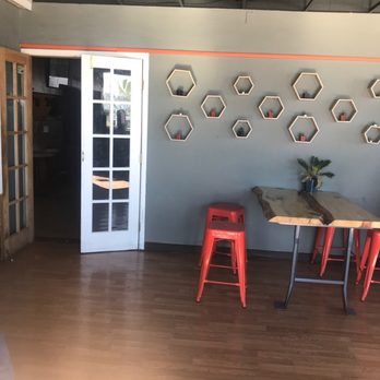 Sirphey - a room with a table and red stools - Food Delivery Services Near Me - Los Alamos, New Mexico