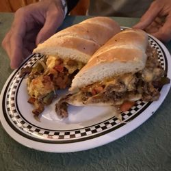 Inn Between Steak & Seafood Restaurant - cheese steak sandwich