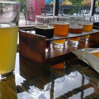 Wet Dogs Brewing - Pint of Mango Cart and flight of Wet Dog beers with pretzels - Breweries Near Me - Lake Placid, Florida