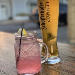 a pink drink and a glass of beer