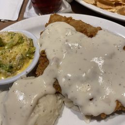 Chicken fried steak, mashed potatoes and broccoli casserole. There's also a piece of toast underneath the chicken fried steak.